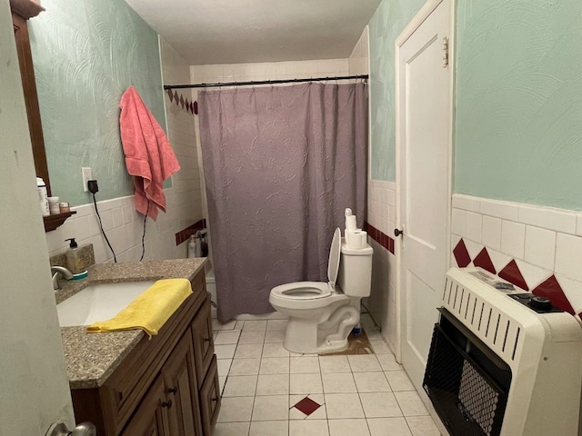 bathroom with vanity, tasteful backsplash, toilet, and tile walls