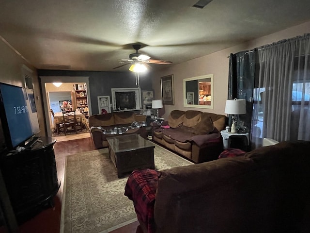 living room with ceiling fan and dark hardwood / wood-style flooring