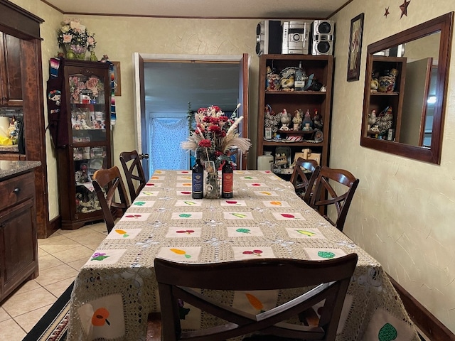 dining area featuring light tile floors