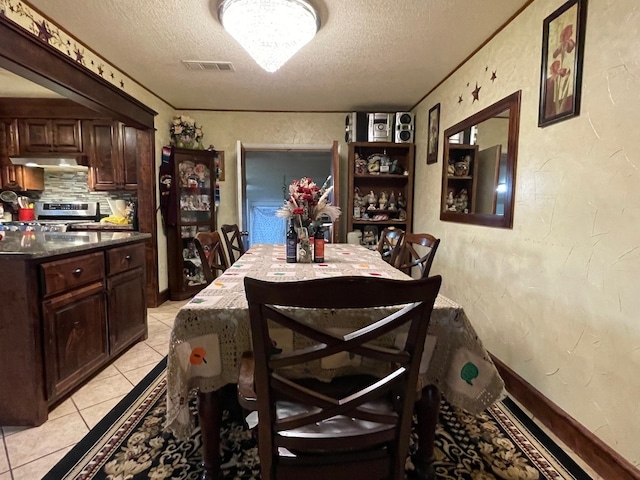 dining room featuring light tile floors and a textured ceiling