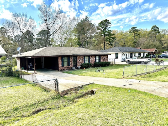 ranch-style home featuring a fenced front yard, brick siding, an attached carport, driveway, and a front lawn