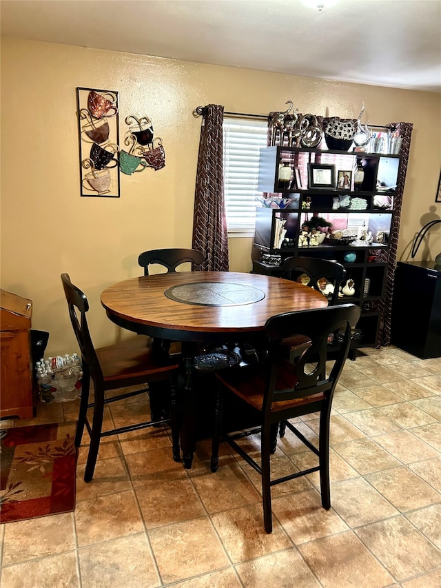 kitchen featuring fridge, sink, and light tile floors