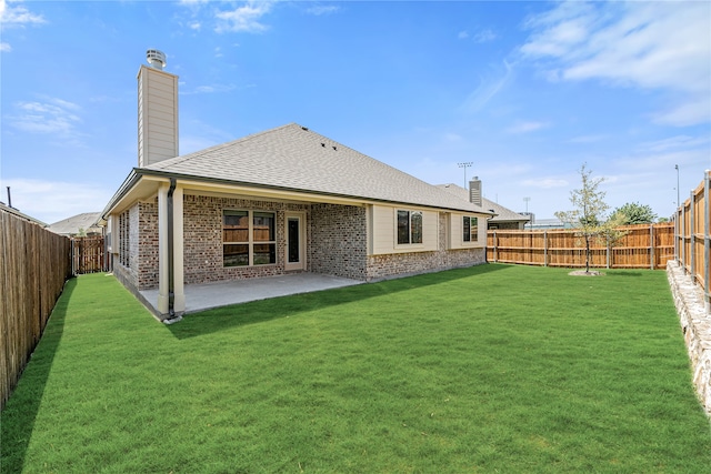 rear view of house featuring a patio and a lawn