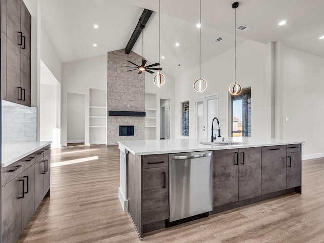 kitchen featuring hanging light fixtures, stainless steel dishwasher, light hardwood / wood-style floors, and a spacious island