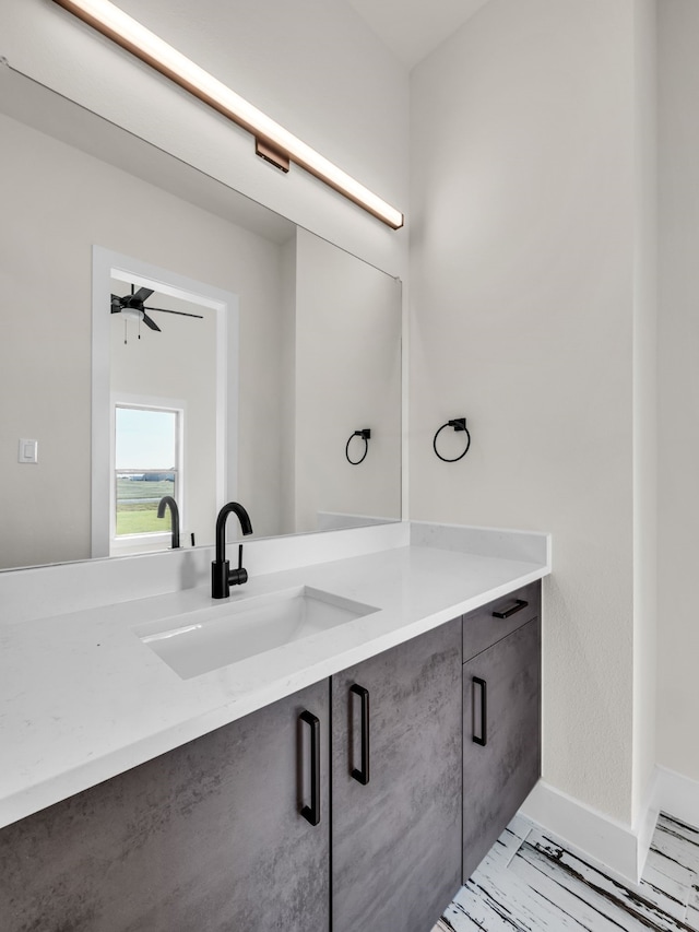 bathroom with ceiling fan and vanity