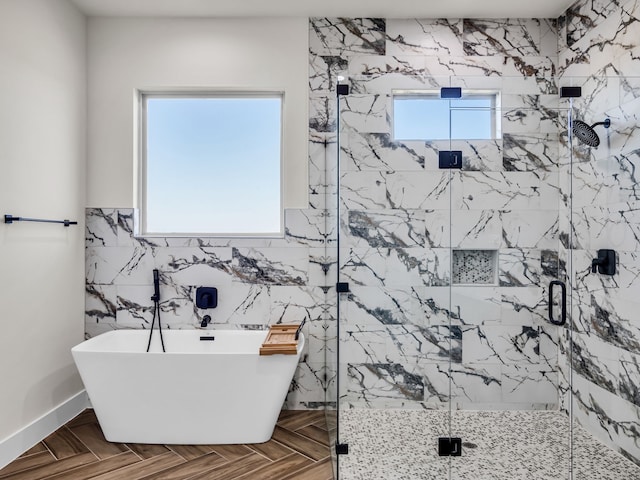 bathroom featuring parquet flooring, plus walk in shower, and a healthy amount of sunlight