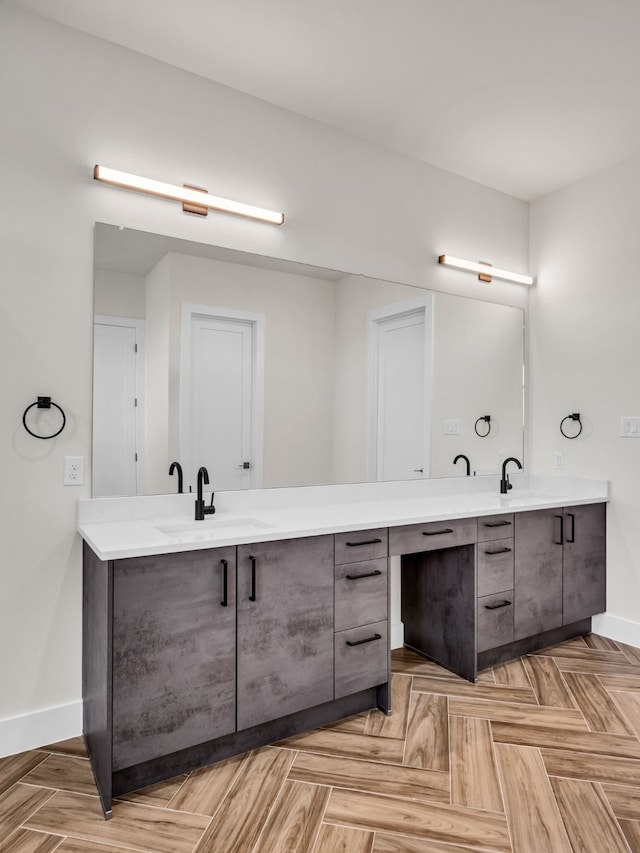 bathroom with vanity and parquet floors