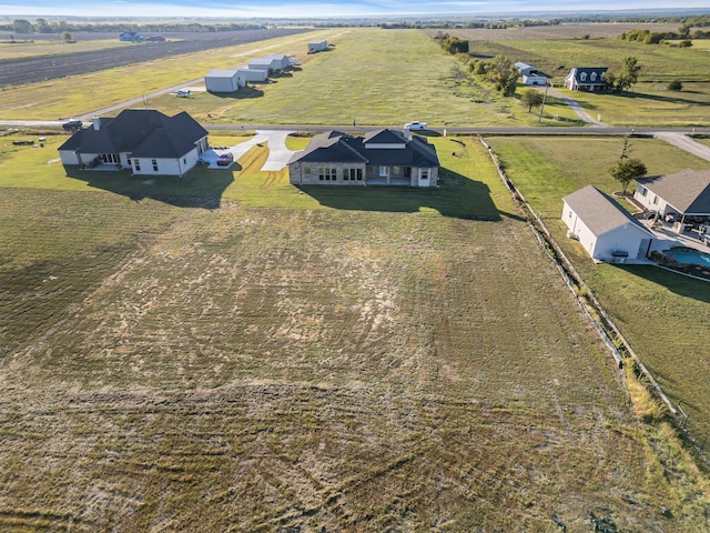 birds eye view of property with a rural view