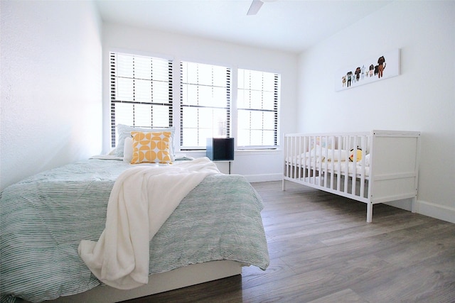 bedroom featuring dark hardwood / wood-style flooring and ceiling fan