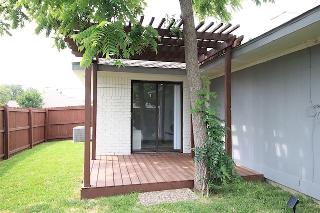 property entrance with central AC unit, a deck, a pergola, and a lawn