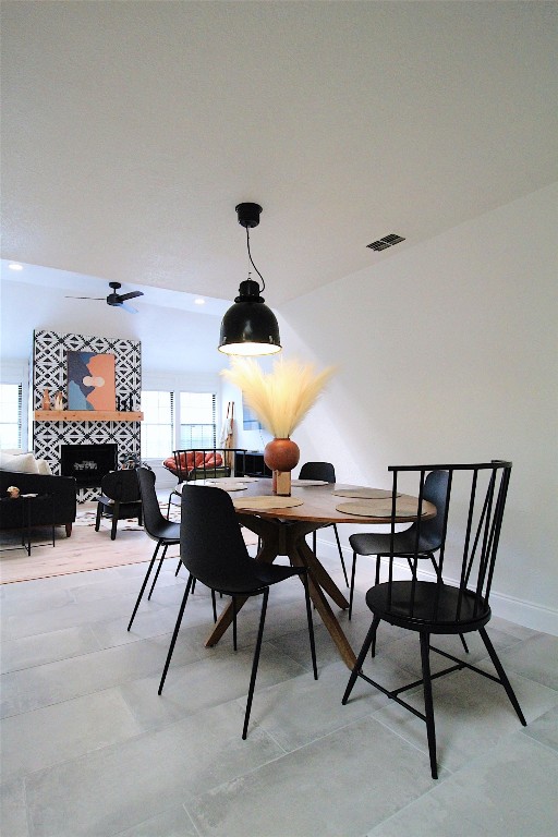 tiled dining space featuring ceiling fan