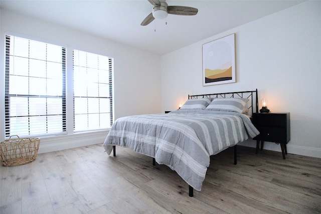 bedroom with light hardwood / wood-style floors and ceiling fan