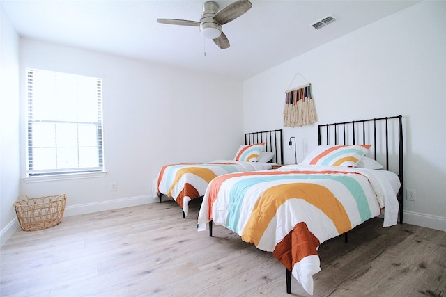 bedroom with light hardwood / wood-style floors and ceiling fan