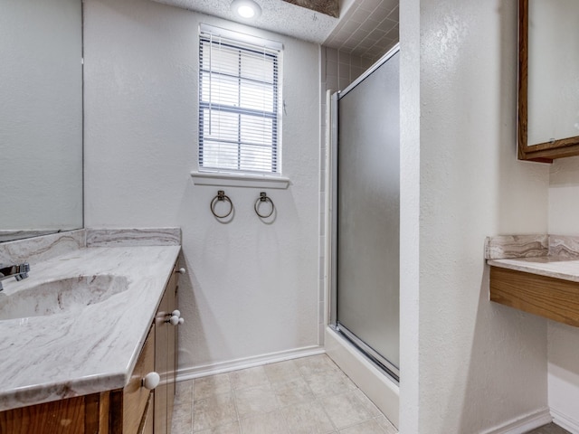 bathroom featuring walk in shower and vanity