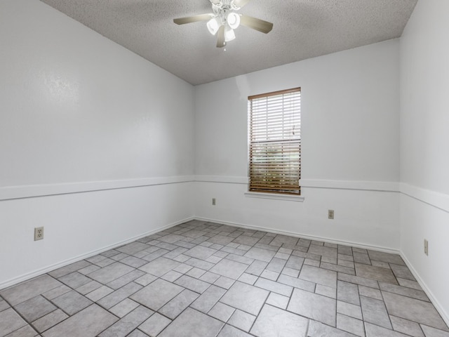 spare room with ceiling fan and a textured ceiling