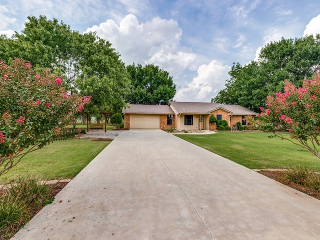 single story home featuring a front lawn and a garage