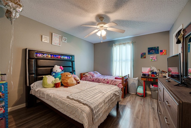 bedroom with hardwood / wood-style floors, a textured ceiling, and ceiling fan