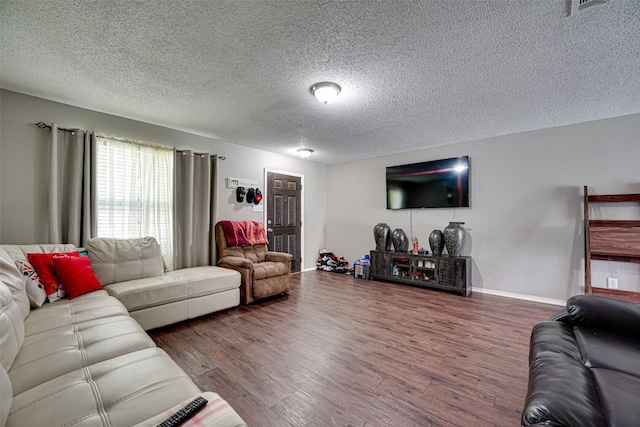 living room with dark wood-type flooring and a textured ceiling