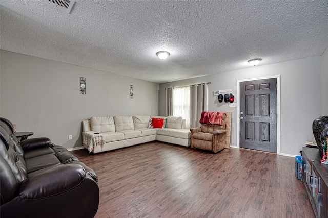 living room featuring dark hardwood / wood-style floors and a textured ceiling