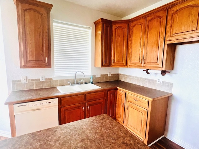 kitchen with hardwood / wood-style floors, sink, and dishwasher