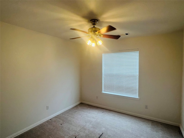 spare room featuring ceiling fan and light colored carpet