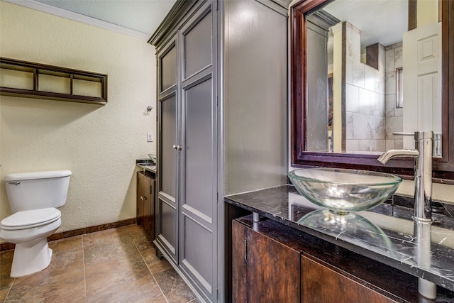 bathroom with crown molding, tile floors, toilet, and vanity