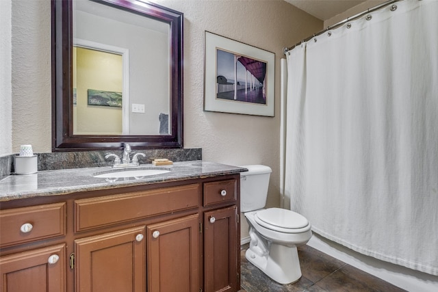 bathroom featuring tile flooring, toilet, and vanity