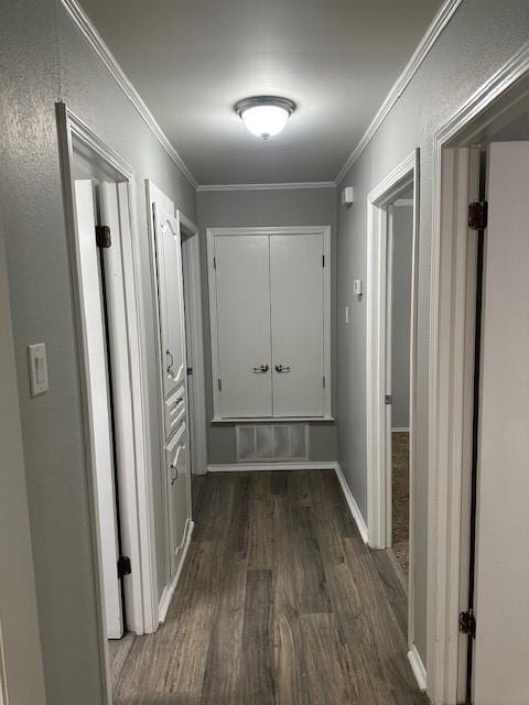 hall featuring crown molding and dark wood-type flooring