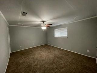 unfurnished room with dark carpet, ceiling fan, and ornamental molding