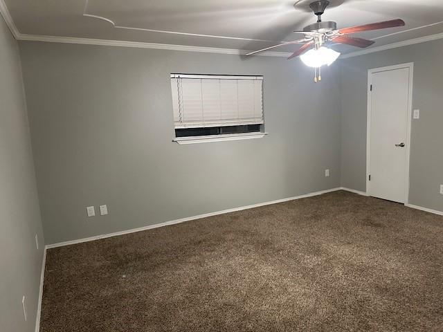 carpeted spare room with ceiling fan and ornamental molding