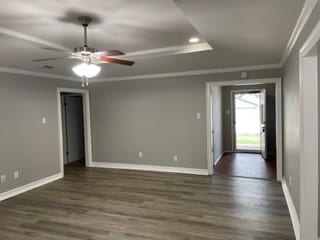 spare room featuring ornamental molding, dark hardwood / wood-style floors, and ceiling fan