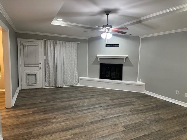 unfurnished living room featuring dark hardwood / wood-style floors, ceiling fan, and ornamental molding