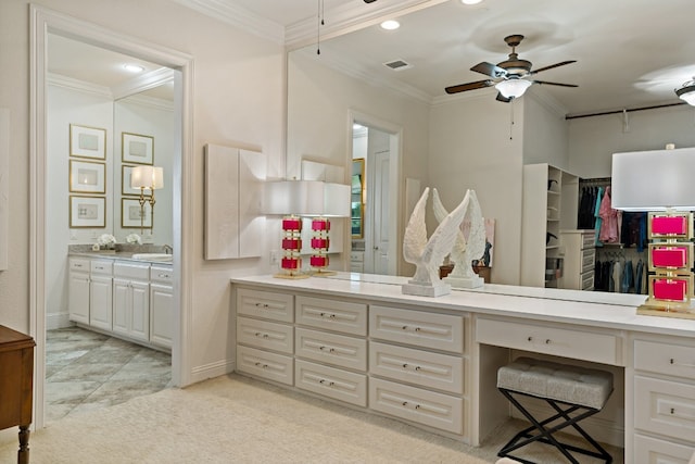 bathroom with crown molding, ceiling fan, and vanity