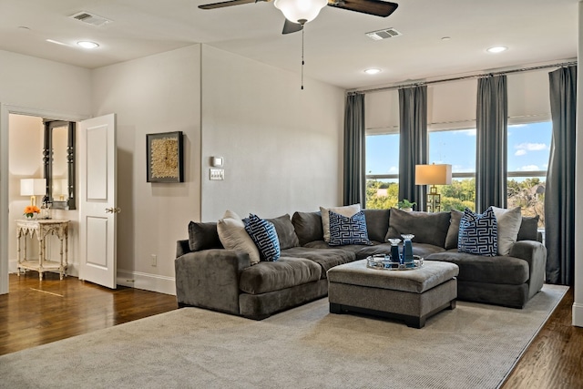 living room with ceiling fan, a healthy amount of sunlight, and dark hardwood / wood-style flooring