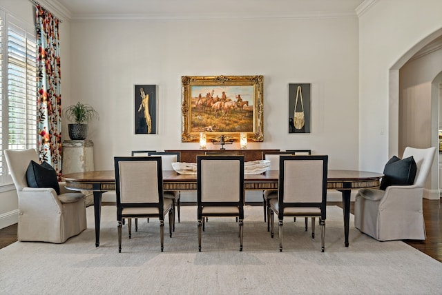 dining space with hardwood / wood-style flooring, ornamental molding, and plenty of natural light