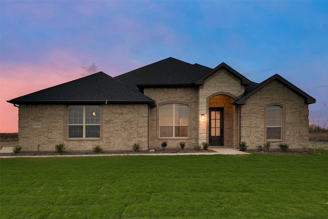 french country home featuring a lawn