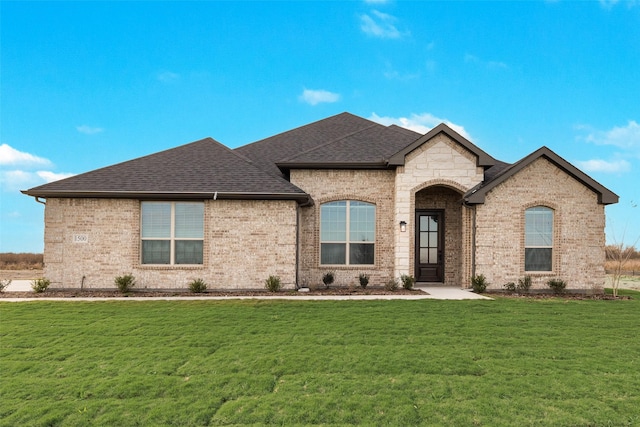 french provincial home with a front lawn