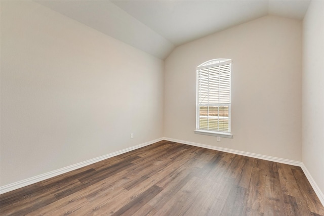 unfurnished room with dark hardwood / wood-style flooring and vaulted ceiling