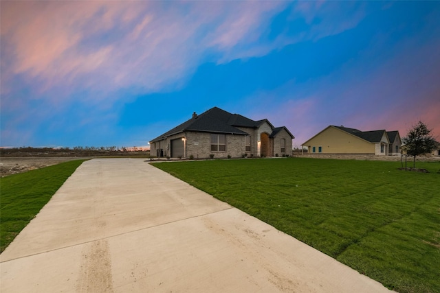 view of front of house with a garage and a yard