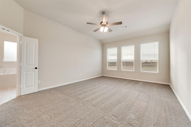 carpeted empty room with ceiling fan and lofted ceiling