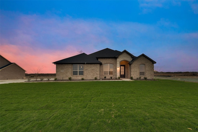 french provincial home featuring a lawn