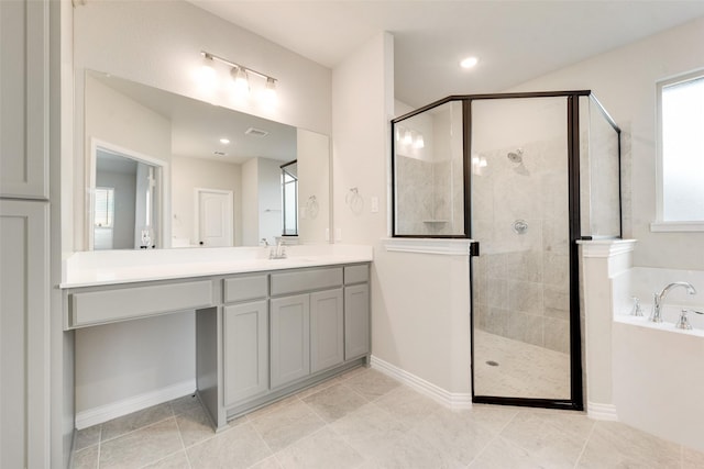 bathroom with independent shower and bath, vanity, and tile patterned floors