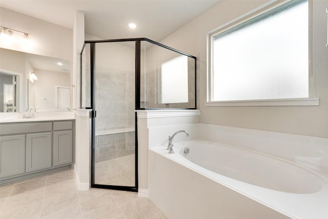 bathroom with vanity, tile patterned flooring, and shower with separate bathtub