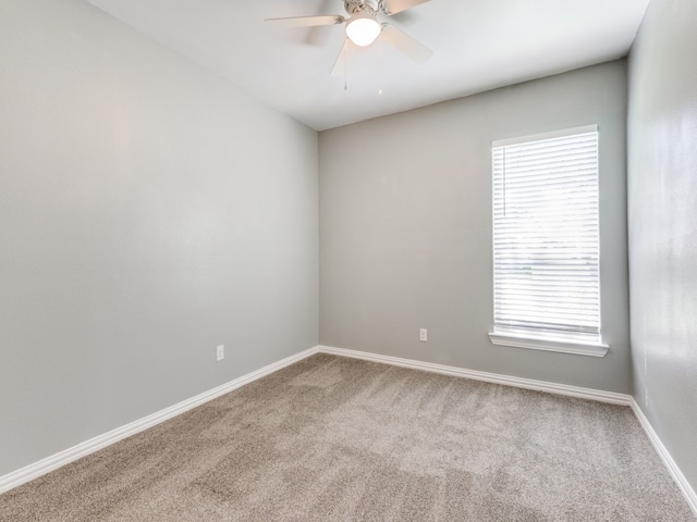 unfurnished room with ceiling fan, light colored carpet, and a healthy amount of sunlight