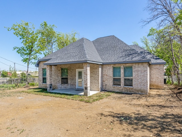 rear view of house featuring central air condition unit and a patio area