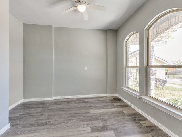 empty room with ceiling fan and dark hardwood / wood-style floors