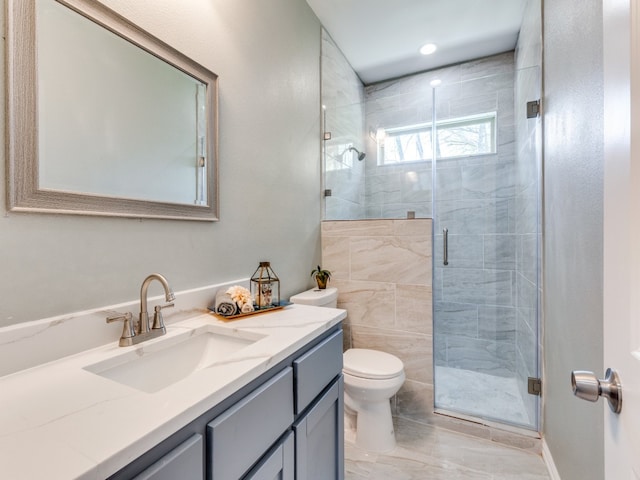 bathroom featuring toilet, tile floors, a shower with shower door, and oversized vanity