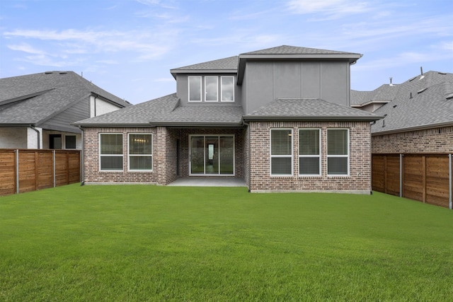 1841 Jasmine June, Mesquite, TX 75181 - back of property featuring brick siding, a fenced backyard, roof with shingles, and a yard