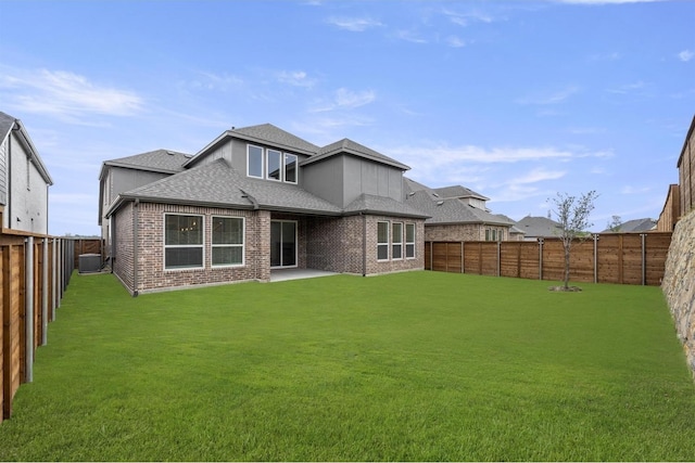 1841 Jasmine June, Mesquite, TX 75181 - rear view of house with central air condition unit, brick siding, a fenced backyard, a yard, and a shingled roof