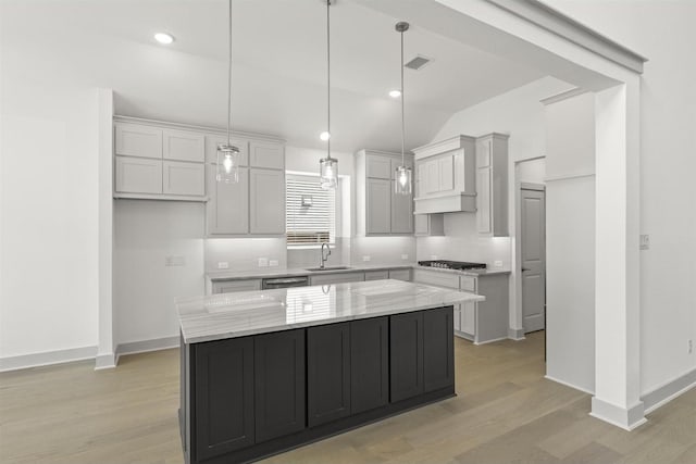 1841 Jasmine June, Mesquite, TX 75181 - kitchen featuring light stone countertops, light wood-style floors, stainless steel appliances, a kitchen island, and vaulted ceiling